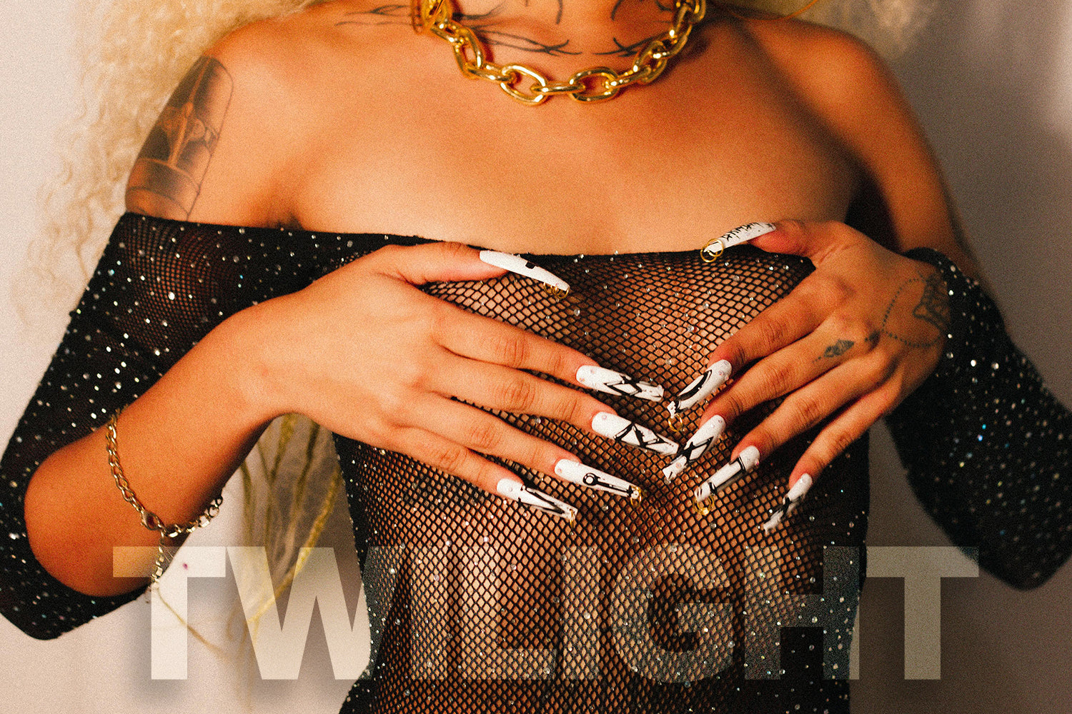 Model showcasing bold nails in a shimmering mesh outfit, embodying the edgy style of the Twilight Collection.